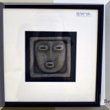A34. Framed stone face 